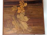 a picture of a wooden table with a flower design on it