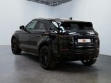 the black range rover is parked in a large room