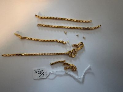a close up of a bunch of gold chains on a table