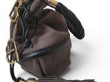 leather bucket bag with tassels on a white background