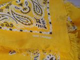 an image of a close up of a yellow scarf with a black and white paisley pattern