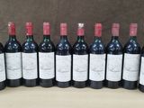 six bottles of wine are lined up on a table