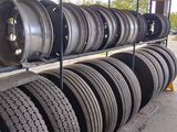 a lot of tires stacked on a rack in a warehouse