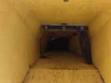 a yellow wall with a hole in the middle of it