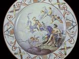 a plate with a painting on it that has angels on it
