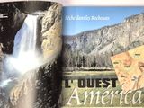 an open book with a picture of a waterfall in the background