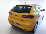 a yellow car that is parked in a garage