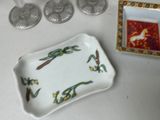 a small tray with a picture on it next to some wine glasses