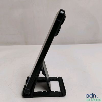 a tablet that is sitting on a stand on the table