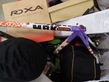 a pile of assorted sports equipment on a bed