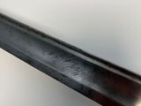 a close up of a knife on a table with a white background