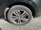 a close up of a car ' s tire on the road
