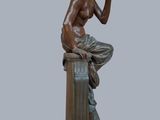 a statue of a man sitting on top of a pedestal