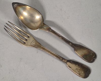 two spoons and a fork sitting on a table