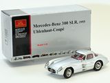 a silver model of a car in front of a box