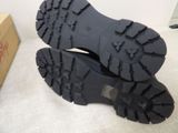a pair of black boots that are on a white surface