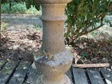 a bird bath sitting on a wooden table in the garden