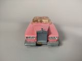 a pink toy car that is sitting on a table