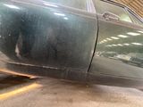 a car that is sitting in a garage with the door open
