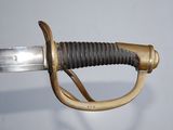 a close up of a sword with a gold handle