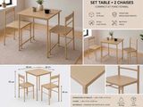 a table and two chairs with a plant on top of it