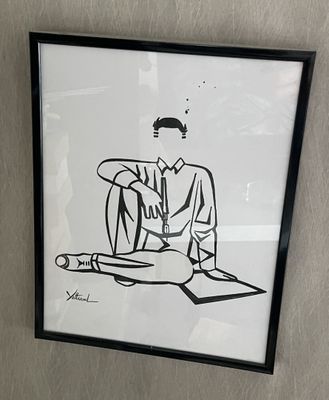 a black and white drawing of a man sitting in a chair