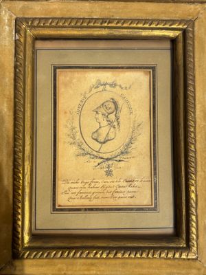 a framed picture of a woman holding a baby in her arms
