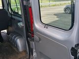 a small van with the door open on a parking lot