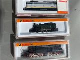 trois trains en boîte posés les uns à côté des autres sur une table