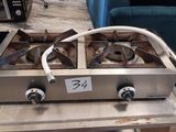two burners that are on a table in a living room
