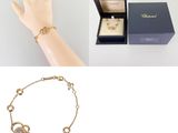 an image of a woman ' s hand holding a bracelet and a box with a ring on it