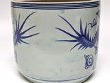 a blue and white planter with a dragon design on it