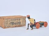 toy figurine of a man sitting in a toy car next to a box
