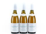 three bottles of wine sitting next to each other on a white surface
