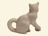 a white cat figurine sitting on a white surface