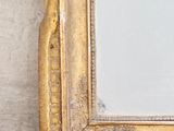 a picture of a mirror hanging on a wall