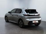 the rear view of a silver car parked in a white room