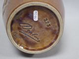 a close up of a brown vase with writing on it