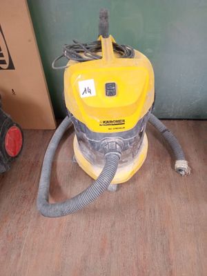 a yellow vacuum cleaner sitting on the floor next to a box