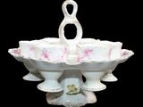 a white bowl with pink flowers in it on a black background