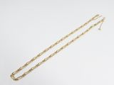 a gold chain necklace with a long link on a white background