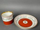 pair of red and white cups and saucers with gold rims