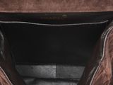 the inside of a brown leather bag with a zipper