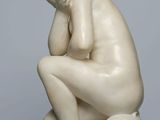 marble statue of a man kneeling on a marble base
