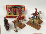 several figurines of soldiers and horses are displayed on a table