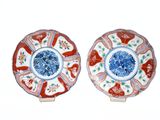 two red and blue plates with flowers on them on a white surface