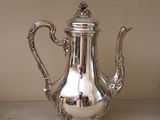 a silver tea pot sitting on a counter top