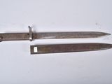 two old knives are laying side by side on a white surface