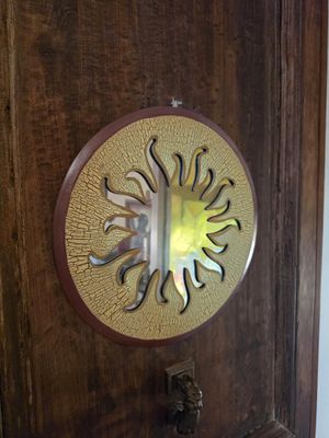 a wooden door with a decorative mirror on it