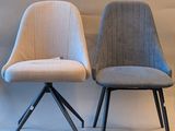 three chairs are sitting next to each other on a white surface